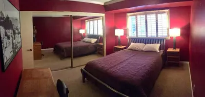 a red bedroom with a bed and a mirror at Room in Bay Park, San Diego in San Diego
