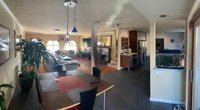 a kitchen and living room with a table and a couch at Room in Bay Park, San Diego in San Diego