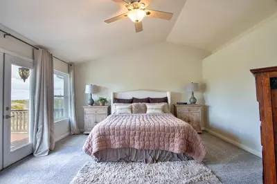 a bedroom with a bed and a ceiling fan at Casa da Saudade in Temecula