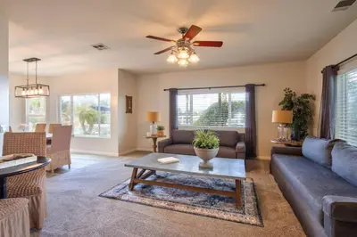 a living room with a couch and a ceiling fan at Casa da Saudade in Temecula