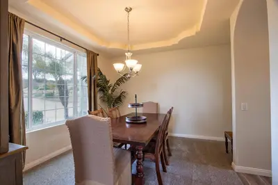 a dining room with a table and chairs and a window at Casa da Saudade in Temecula