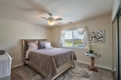 a bedroom with a bed and a ceiling fan at Casa da Saudade in Temecula