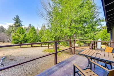 a deck with a table and chairs on a fence at Near Hiking and Mtn Biking Cozy Cabin in Mt Laguna! in Mount Laguna