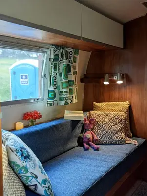 a teddy bear sitting on a bed in a room at Artsy Airstream for a California Glamping Weekend near San Diego in San Marcos