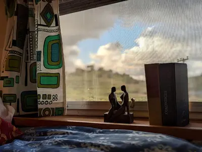 a couple figurines sitting on a window sill next to a book at Artsy Airstream for a California Glamping Weekend near San Diego in San Marcos