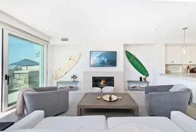 a living room with a couch and a fireplace at Oceanfront Escape with Breathtaking Views in Newport Beach