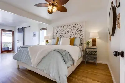 a bedroom with a bed and a ceiling fan at Bali Beach in San Diego