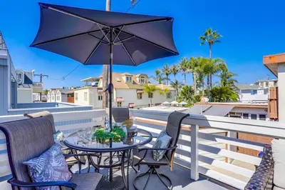 a patio with a table and chairs and an umbrella at Bali Beach in San Diego