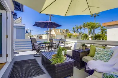 a patio with a table and chairs and an umbrella at Bali Beach in San Diego
