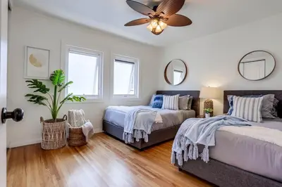 a bedroom with two beds and a ceiling fan at Bali Beach in San Diego