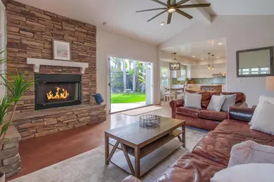 a living room with a couch and a fireplace at Leucadia Paradise in Encinitas