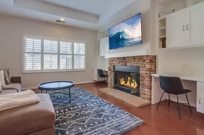 a living room with a couch and a fireplace at Leucadia Paradise in Encinitas
