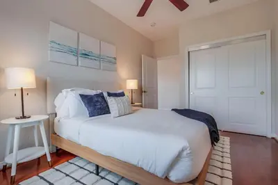 a bedroom with a white bed and a white door at Leucadia Paradise in Encinitas
