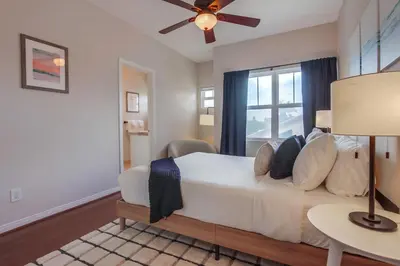 a bedroom with a white bed and a window at Leucadia Paradise in Encinitas