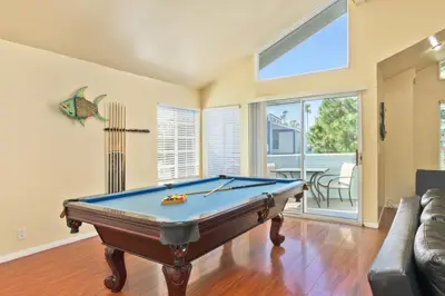 a living room with a pool table in it at Seas the Fun in Newport Beach