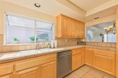 a kitchen with wooden cabinets and a window at Seas the Fun in Newport Beach