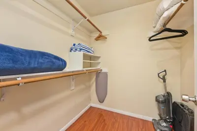 a room with a bed and a wooden shelf at Seas the Fun in Newport Beach