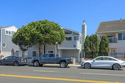a truck and a car parked in front of a house at Seas the Fun in Newport Beach