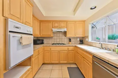 a kitchen with wooden cabinets and a window at Seas the Fun in Newport Beach