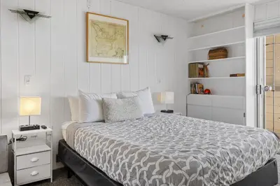 a bedroom with a bed and a map on the wall at Shoreline Hideaway in San Diego