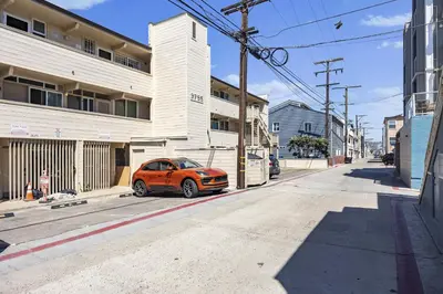 an orange car parked on a street next to a building at Shoreline Hideaway in San Diego