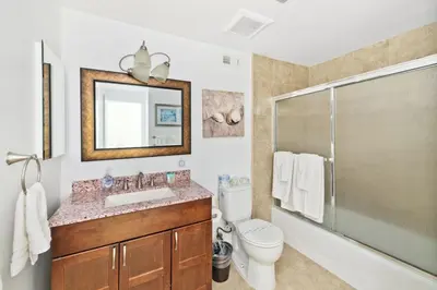 a bathroom with a sink and a shower and a toilet at Spacious Oceanfront Home Near Newport Pier in Newport Beach