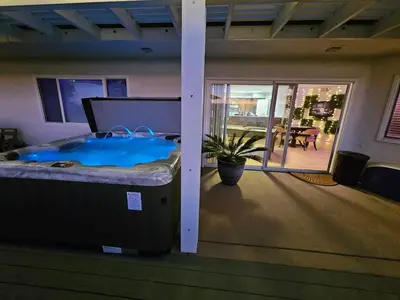 a jacuzzi tub in a room with a patio at La Jolla Gem with Ocean View - 11 Beds, Hot Tub, Karaoke & Game Den in San Diego