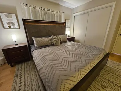a bedroom with a large bed with a bow on it at La Jolla Gem with Ocean View - 11 Beds, Hot Tub, Karaoke & Game Den in San Diego