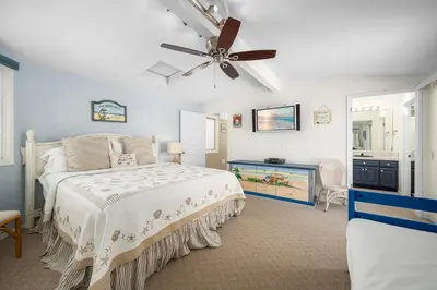a bedroom with a bed and a ceiling fan at Luxurious Oceanfront Home with Incredible Views in Newport Beach