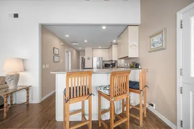 a kitchen with a bar with two chairs at Luxurious Oceanfront Home with Incredible Views in Newport Beach