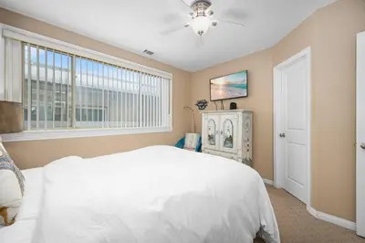 a bedroom with a white bed and a window at Luxurious Oceanfront Home with Incredible Views in Newport Beach
