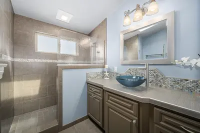 a bathroom with a sink and a mirror at Luxurious Oceanfront Home with Incredible Views in Newport Beach
