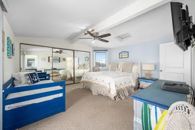 a bedroom with a bed and a mirror at Luxurious Oceanfront Home with Incredible Views in Newport Beach