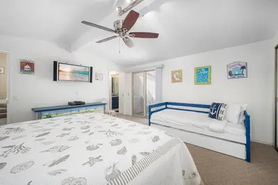 a bedroom with a bed and a ceiling fan at Luxurious Oceanfront Home with Incredible Views in Newport Beach