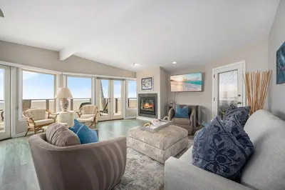 a living room with couches and a fireplace at Luxurious Oceanfront Home with Incredible Views in Newport Beach