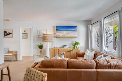 a living room with a brown leather couch at NEW Boho-Beach House in San Diego