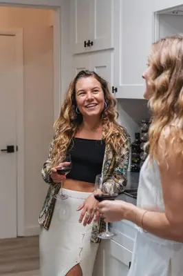 two women standing in a kitchen holding wine glasses at NEW Boho-Beach House in San Diego
