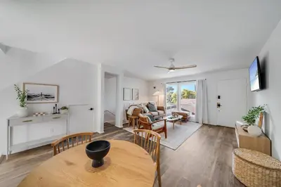 a living room with a table and a dining room at Boho Beach Bungalow Walk to the Beach in San Diego