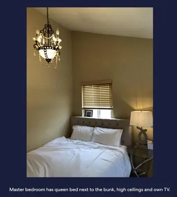 a bedroom has a bed next to a chandelier at Ocean Front Beauty right above Best Beach in Mission Beach, San Diego! in San Diego