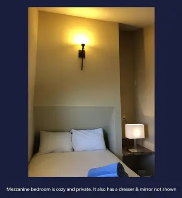 a room with a bed with a cross on the wall at Ocean Front Beauty right above Best Beach in Mission Beach, San Diego! in San Diego