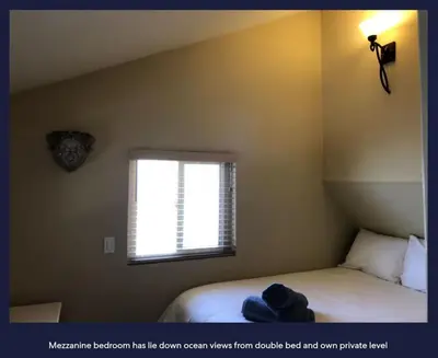 a small bedroom with a bed and a window at Ocean Front Beauty right above Best Beach in Mission Beach, San Diego! in San Diego