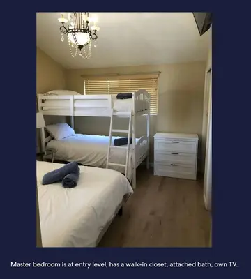 a bedroom with two bunk beds and a chandelier at Ocean Front Beauty right above Best Beach in Mission Beach, San Diego! in San Diego