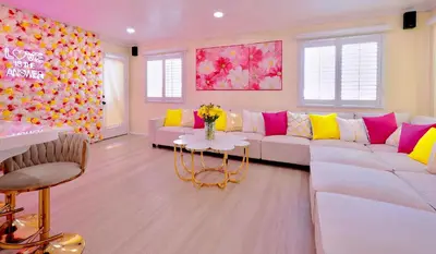 a living room with a white couch and a table at Casa de Bloom Venue - Your Perfect Event Space in San Diego