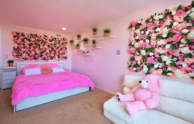 a pink bedroom with a pink bed and flowers on the wall at Casa de Bloom Venue - Your Perfect Event Space in San Diego