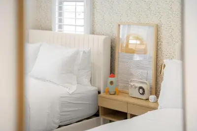 a bedroom with a bed with a mirror and a alarm clock at Modern Elegant Designer Home in Irvine in Irvine