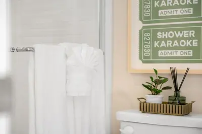 a bathroom with a green sign above a toilet at Modern Elegant Designer Home in Irvine in Irvine