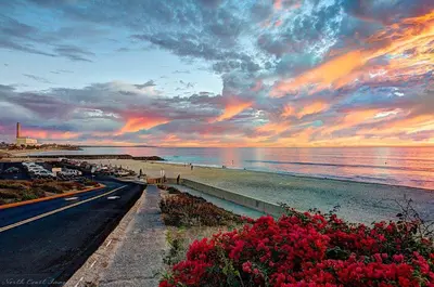 a road next to a beach with a sunset at Tropical retreat for whole family Fresh eggs Made to Entertain in Carlsbad
