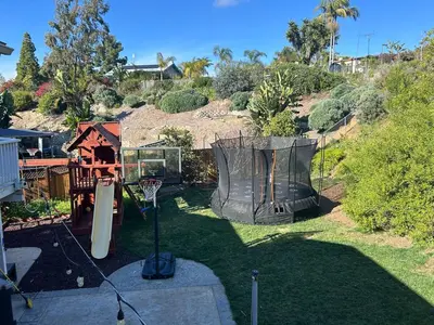 a back yard with a basketball hoop and a basketball hoopintend at Tropical retreat for whole family Fresh eggs Made to Entertain in Carlsbad