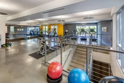 a gym with several treadmills and exercise equipment at Charming 3 Bedroom Apartment with Pool Near San Diego Convention Center in San Diego