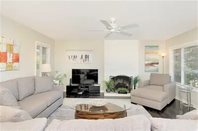 a living room with a couch and a table at Viewpoint Villa - VILLA105 in Solana Beach